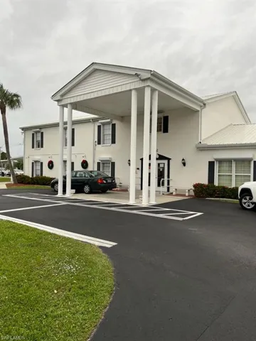 View of property with uncovered parking