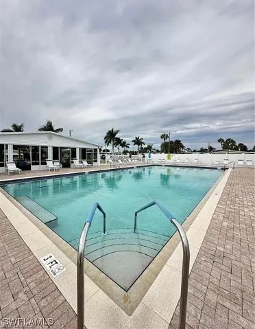 Community pool featuring a patio