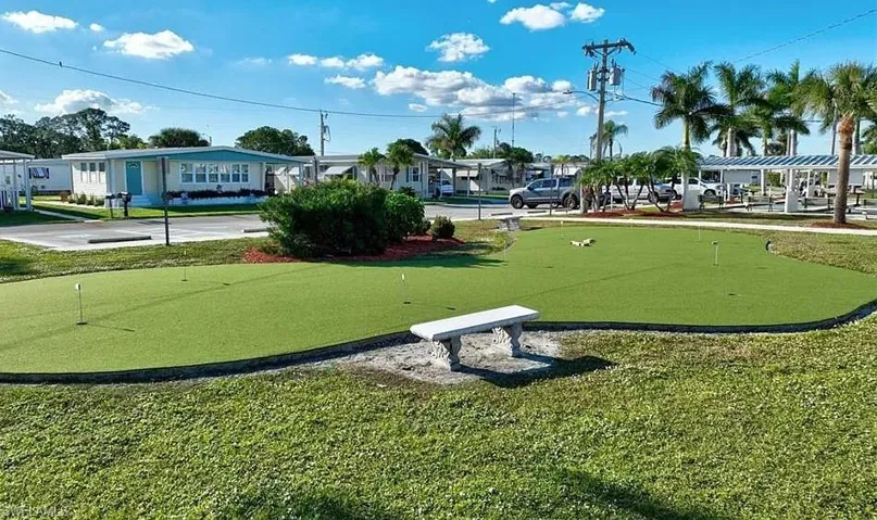 View of home's community featuring an area to practice putting and a residential view