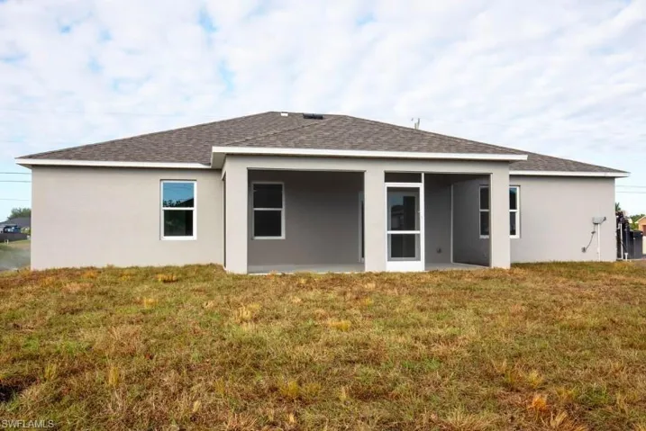 Back of the Home with Screened in Lanai and Spacious Backyard!