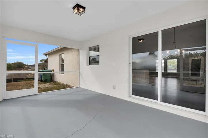 Unfurnished sunroom with healthy amount of natural light and suspended lighting