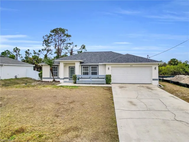 Single story home with stucco siding, a shingled roof, concrete driveway, and an attached garage