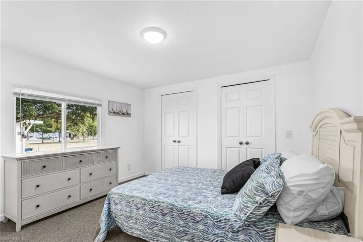 Carpeted room with a large window