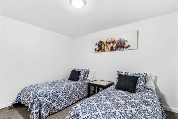 Neutral white walls featuring a flush-mount ceiling light