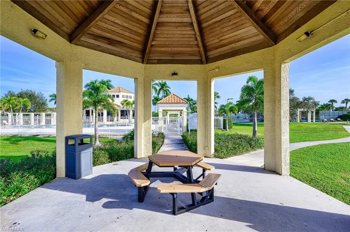View of patio with a gazebo and a community pool