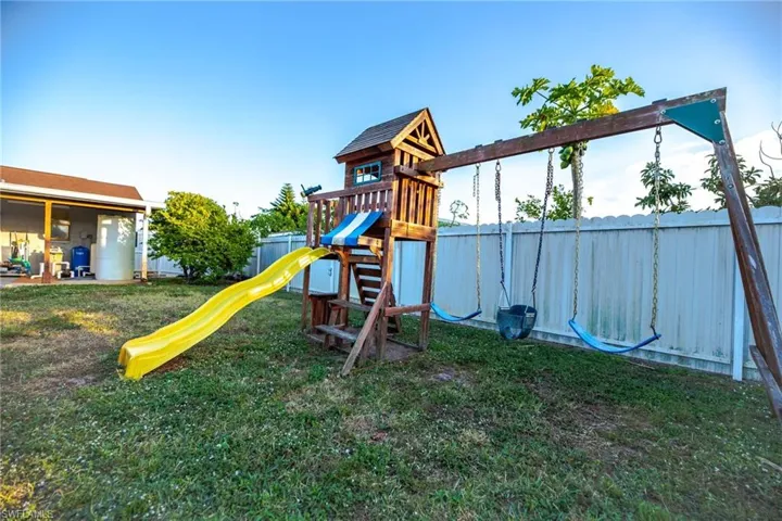 View of playground with a lawn
