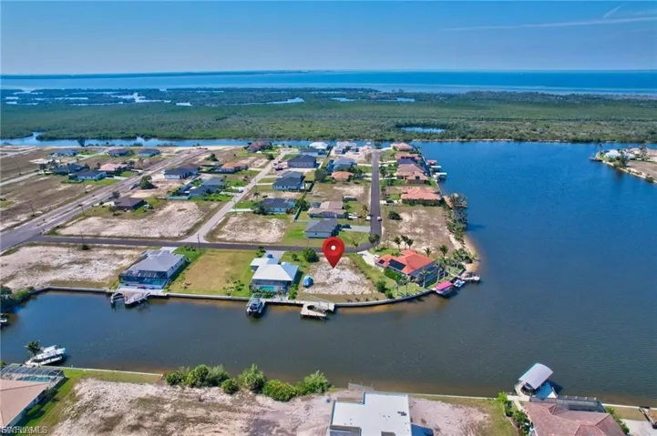 Aerial view of residential area featuring a large body of water