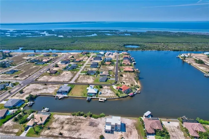 Aerial perspective of suburban area with a large body of water