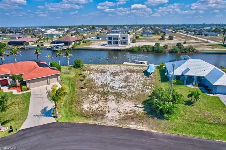 Aerial view of residential area featuring a nearby body of water