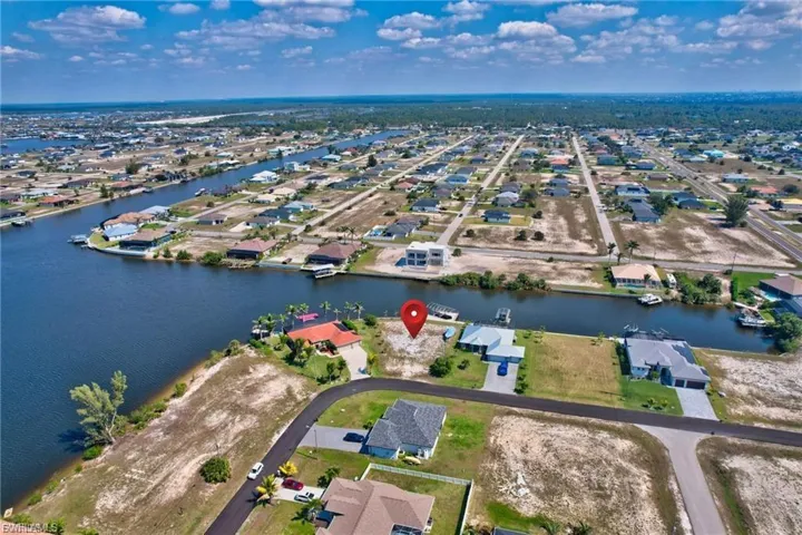 Aerial perspective of suburban area featuring a large body of water