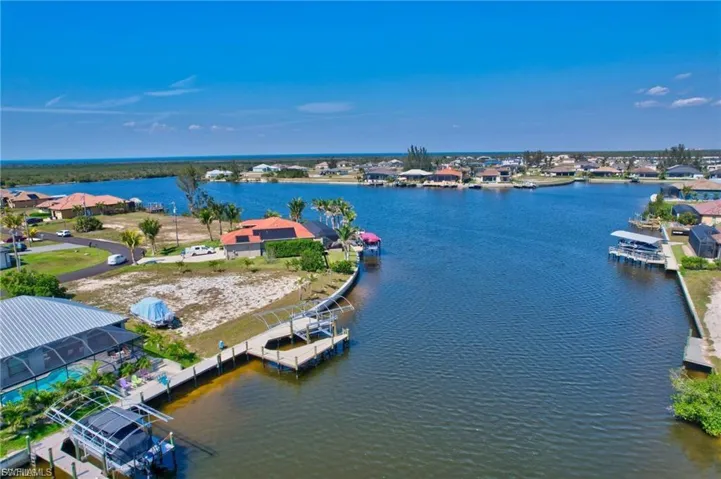 Aerial perspective of suburban area featuring a large body of water