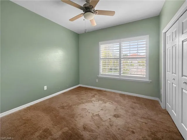 Unfurnished bedroom with carpet floors, a closet, and baseboards