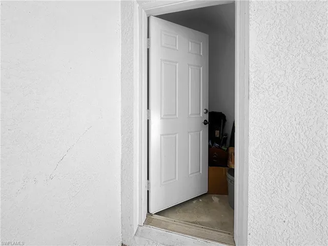 View of exterior entry with stucco siding