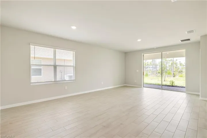 Empty room with light hardwood / wood-style floors