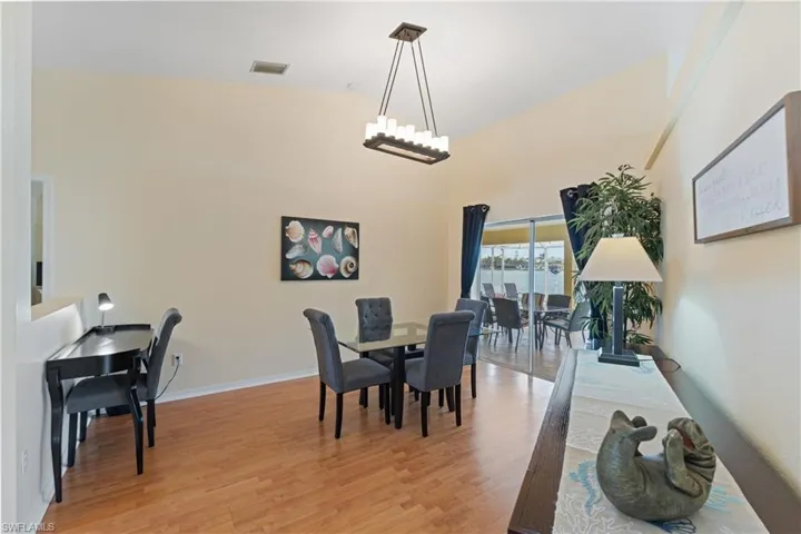 Vaulted ceilings with a rectangular chandelier illuminate the dining area