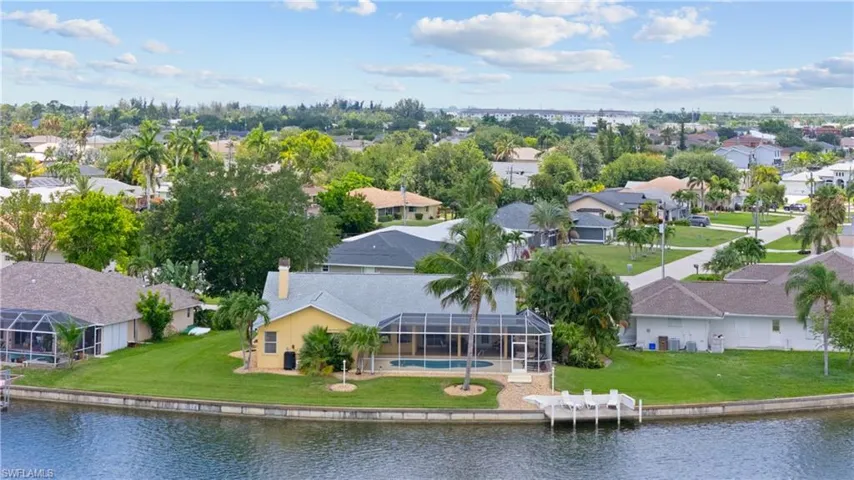 Waterfront residence with a screened lanai and pool, featuring a private dock