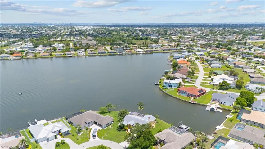 Waterfront homes with private docks and boat lifts, featuring diverse architectural styles and mature landscaping