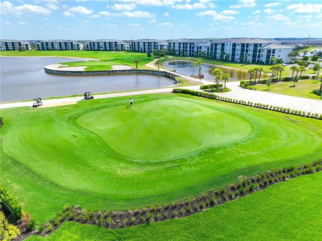 View of home's community with a water view and view of golf course