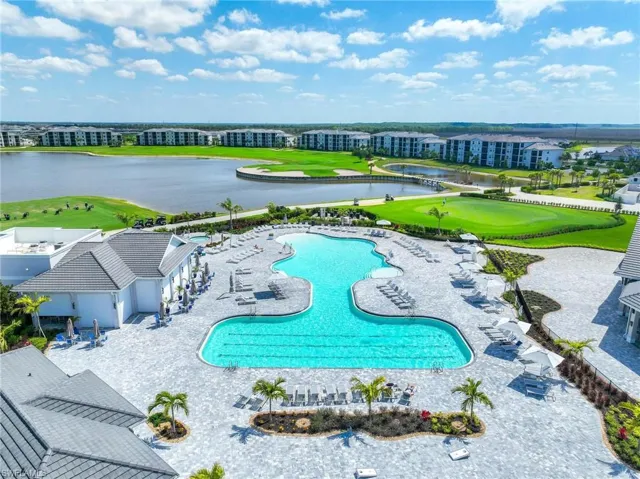 Pool featuring a water view, view of golf course, and a patio