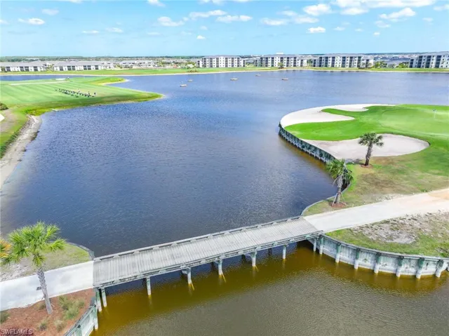 Birds eye view of property featuring a water view and view of golf course