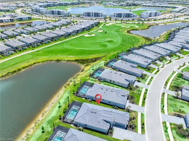 Drone / aerial view featuring a residential view, a water view, and golf course view