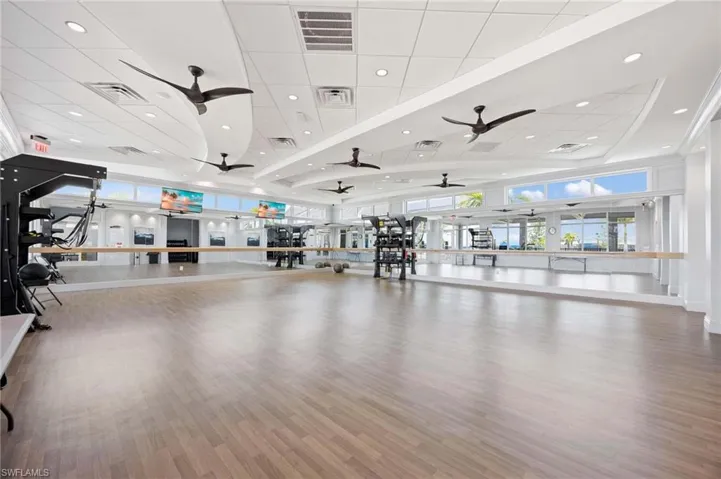 Gym featuring visible vents, a ceiling fan, and a drop ceiling