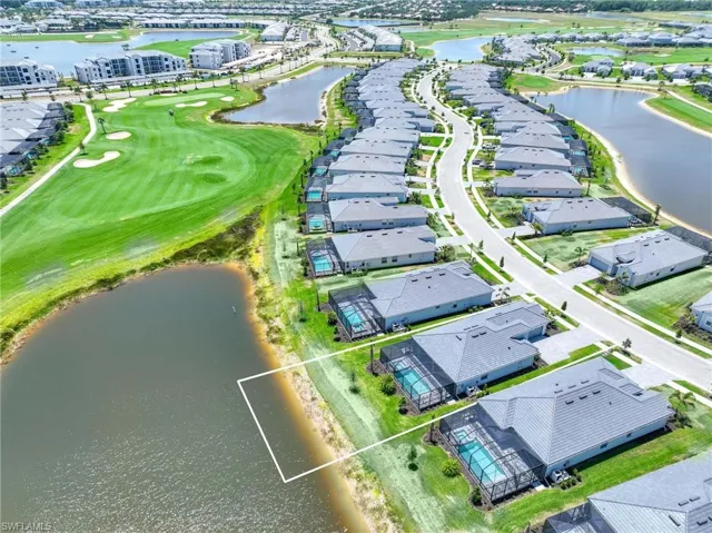 Aerial view with a water view, view of golf course, and a residential view
