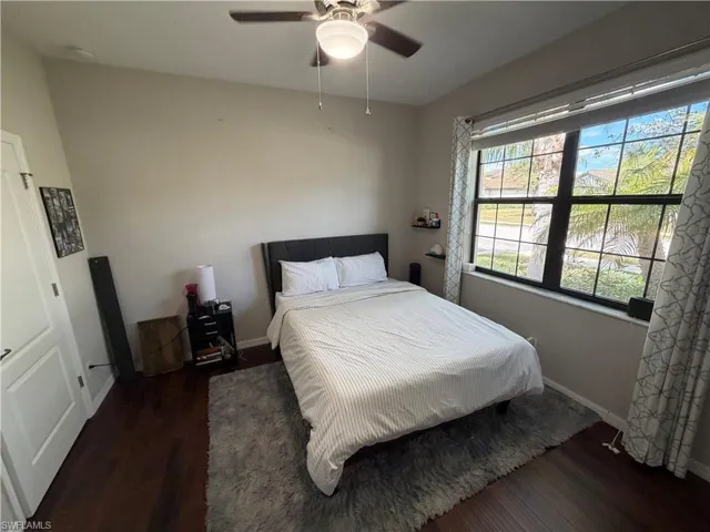 Bedroom featuring dark wood-style floors and ceiling fan