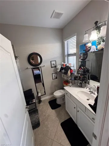 Bathroom with vanity and light tile patterned floors