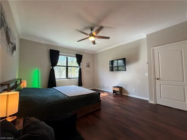 Master Bedroom with dark wood-type flooring, ornamental molding, and a ceiling fan