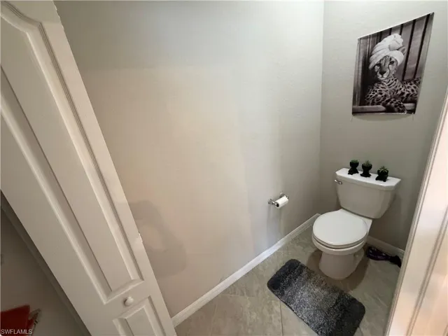 Bathroom featuring toilet and tile patterned floors