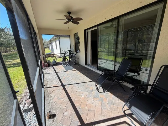 Sunroom featuring a ceiling fan