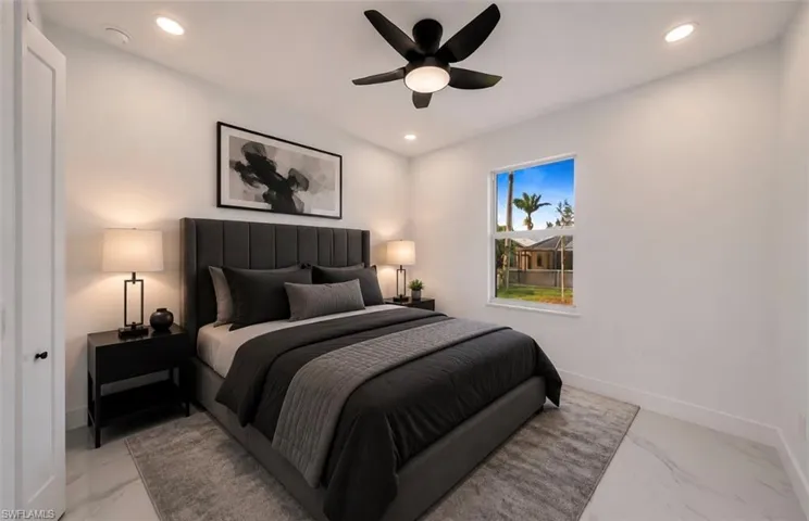 Recessed lighting, ceiling fan with integrated light, hard surface flooring, white interior doors, and a window with exterior scenery