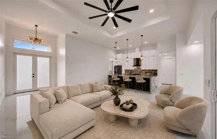 Polished tile flooring, high ceilings with recessed lighting, and a modern ceiling fan
