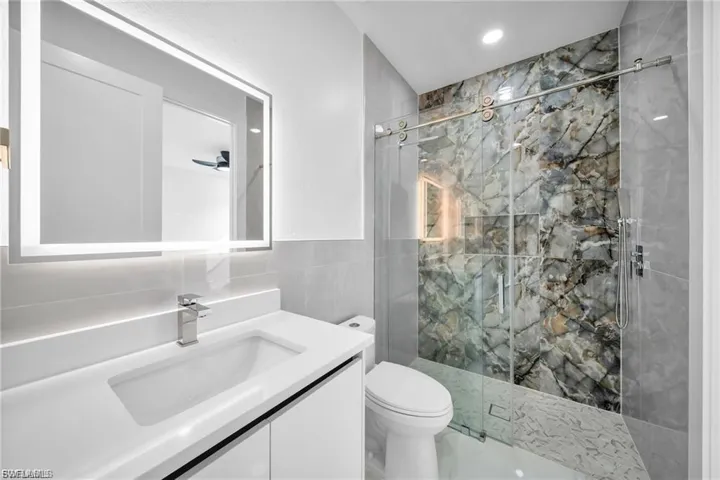 Floating vanity with an integrated sink and chrome faucet