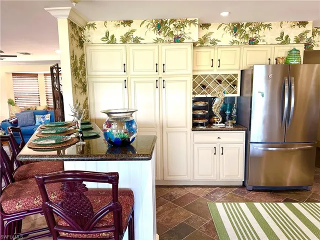 The kitchen boasts stainless steel appliances and has a huge cupboard for spices and supplies.  Breakfast Bar as well.