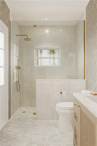 Bathroom featuring walk in shower, vanity, healthy amount of natural light, and wallpapered walls