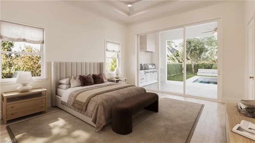 Bedroom with multiple windows, light wood-type flooring, and access to exterior