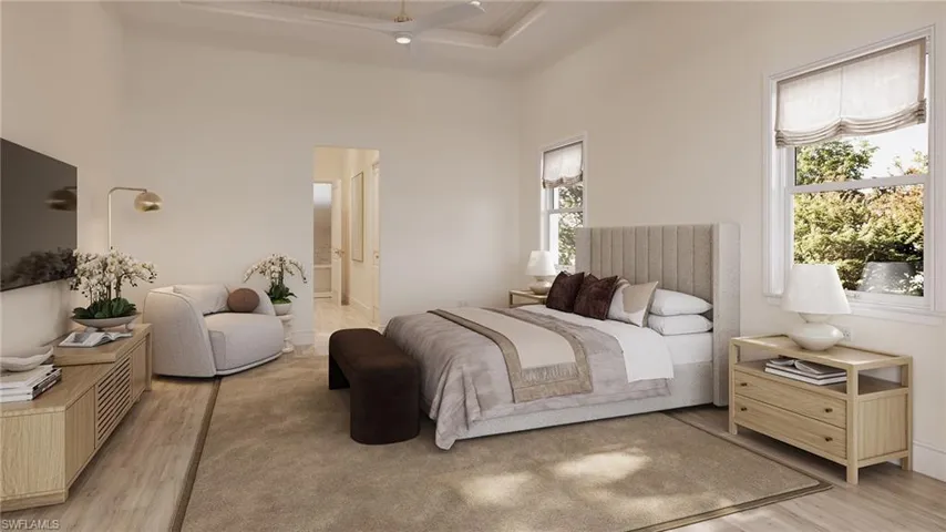 Bedroom featuring light wood-style floors, ensuite bath, and a ceiling fan