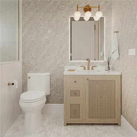 Half bath featuring vanity and light tile patterned flooring