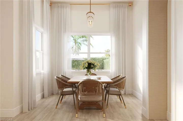 Dining area featuring light wood-style floors and a chandelier