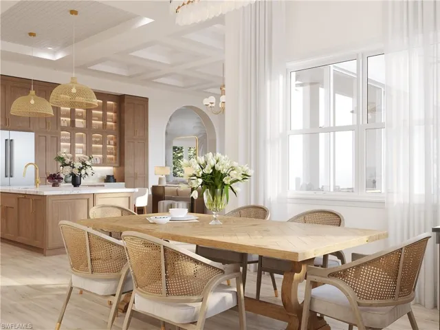 Dining space featuring coffered ceiling, arched walkways, light wood-type flooring, and suspended lighting