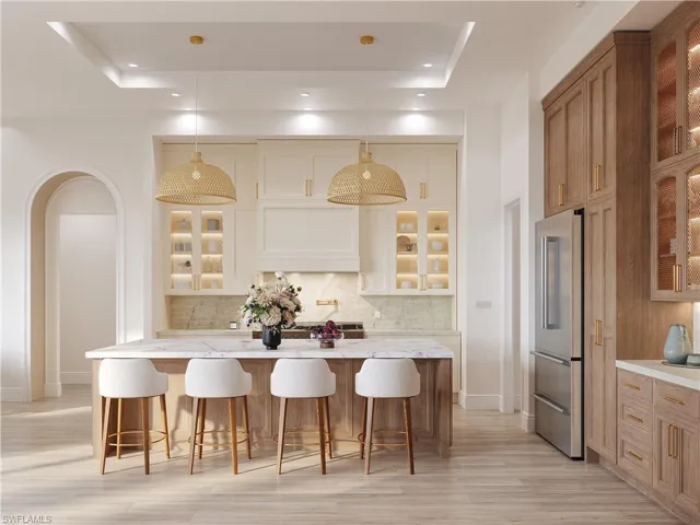 Kitchen with glass insert cabinets, a breakfast bar area, and dual tone cabinets