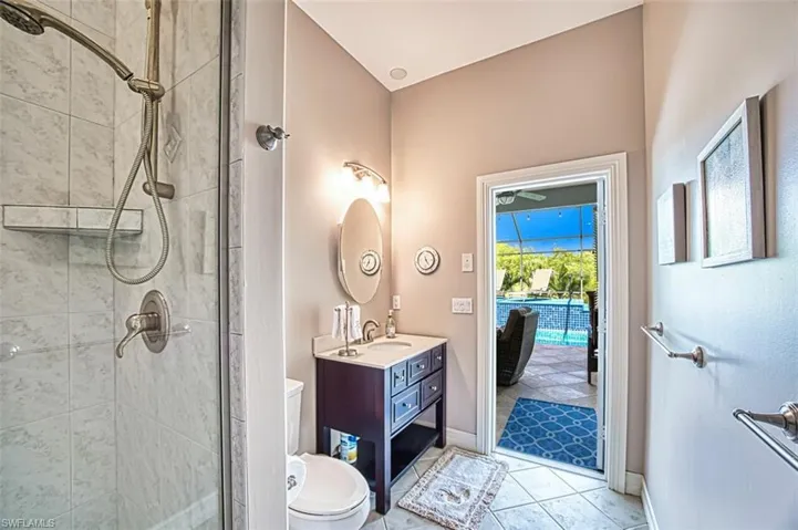 Guest bath with access to pool area.  Shower with glass doors