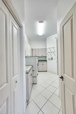 Laundry room with lots of storage cabinets. Laundry tub.