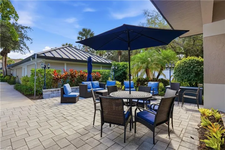 Charming community terrace with comfortable seating and lush tropical surroundings.