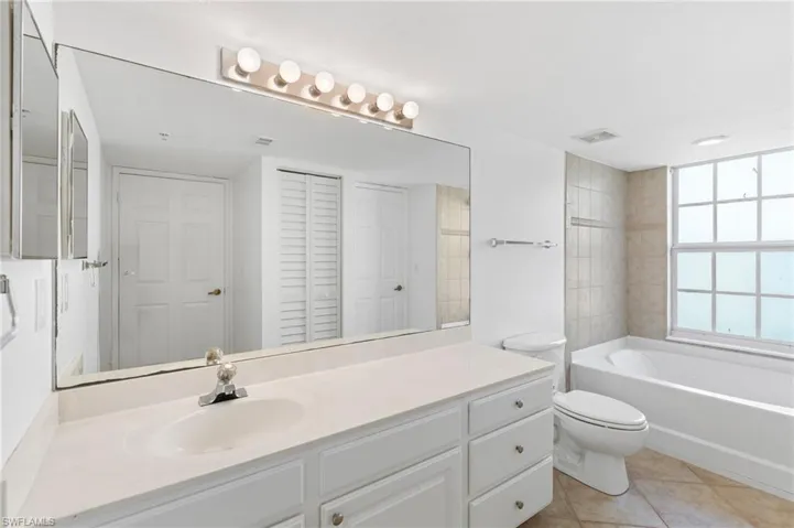 Bathroom with vanity, tile patterned floors, and toilet
