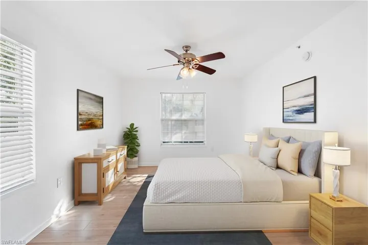 Bedroom with ceiling fan, light wood-type flooring, and baseboards, Virtually Staged