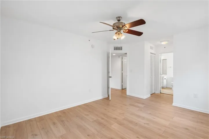 Empty room featuring ceiling fan and light wood-type flooring