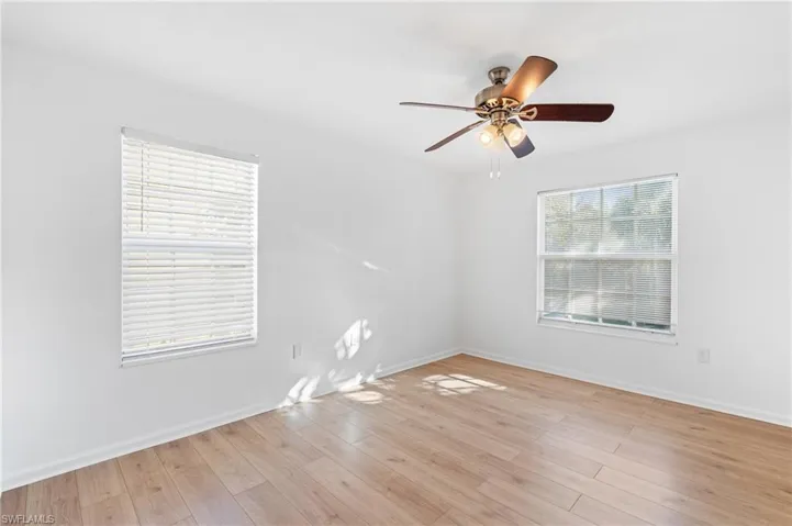 Empty room featuring ceiling fan and light wood-type flooring